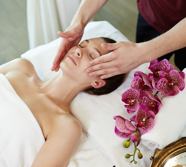 Woman enjoying facial massage at Phuket Spa